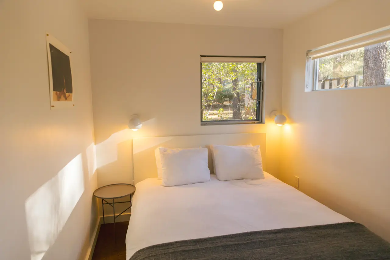 Sleep Inn / C2 bedroom with comfy bed lights on and window view outside at Colorado Lodge Big Bear Lake