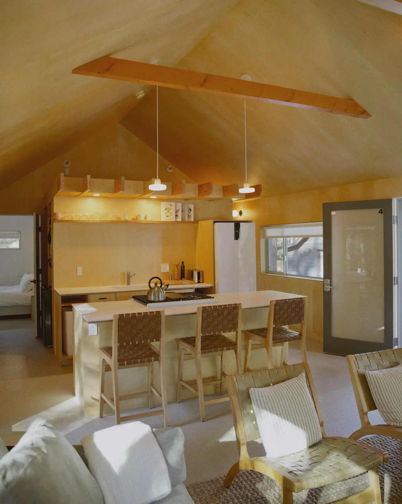 Colorado Lodge / C4 full kitchen with island and a view into the back bedroom at Colorado Lodge boutique lodge in Big Bear Lake