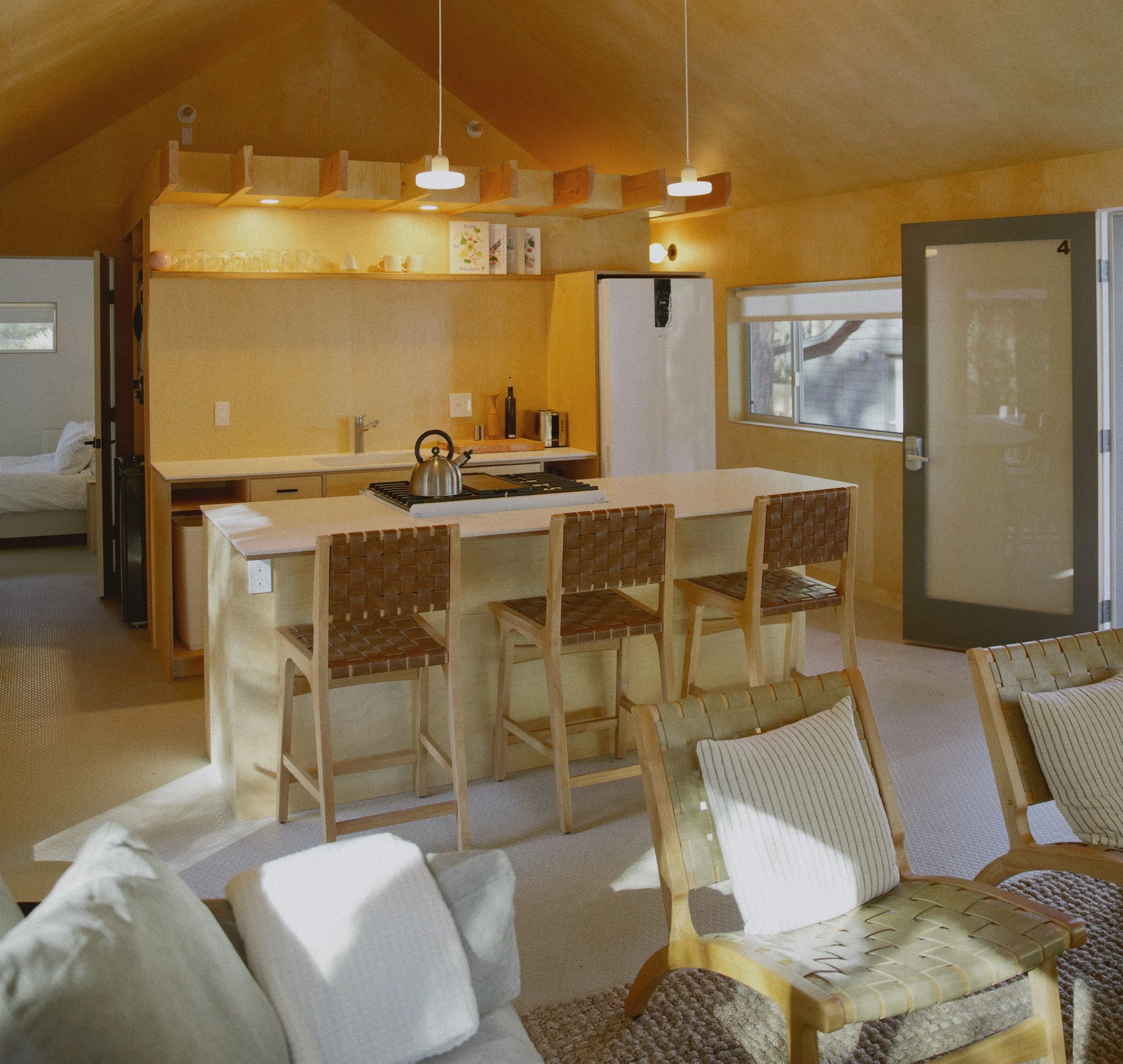 Modern Nordic cabin interior at Colorado Lodge in Big Bear Lake — kitchen and bedroom