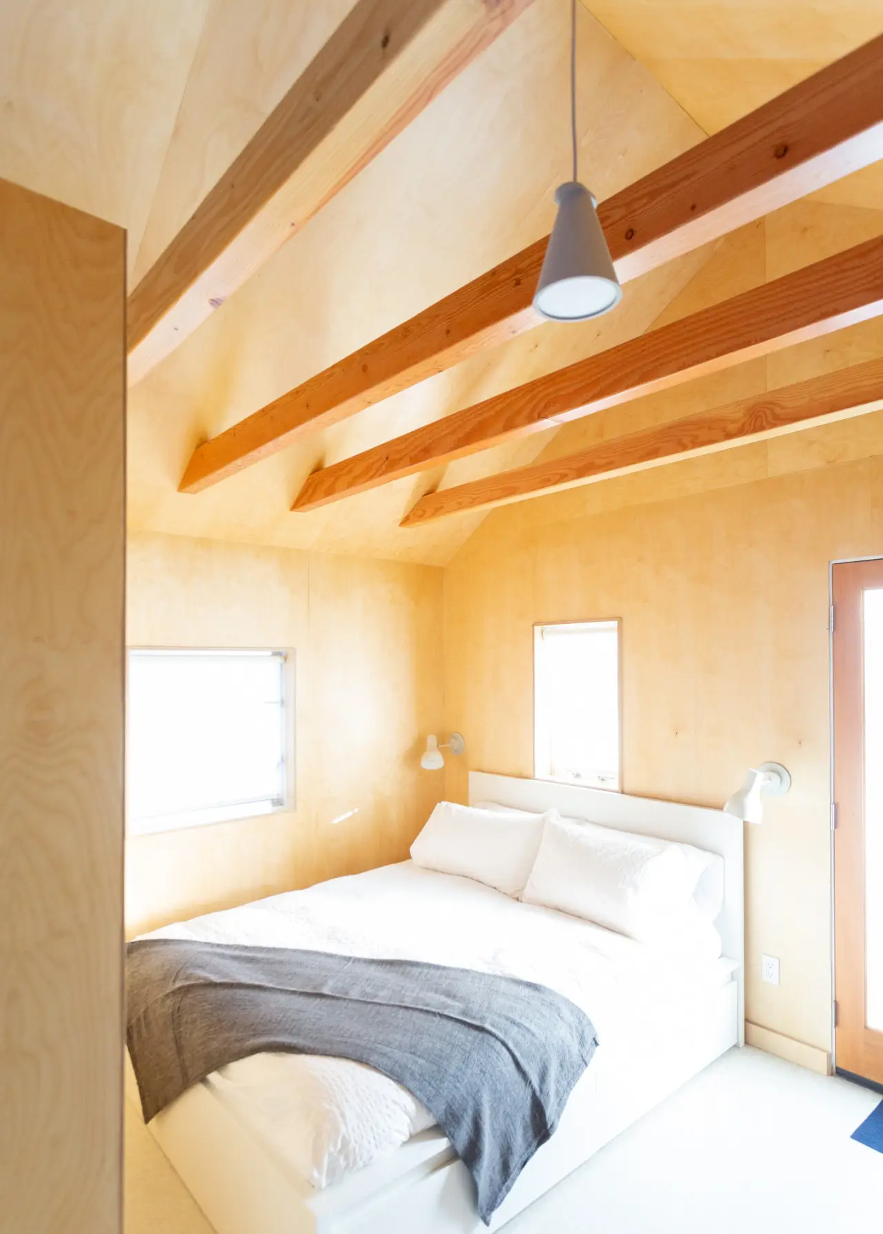 Small + Mighty / C5 studio bedroom area with vaulted ceilings and exposed beams at Colorado Lodge Big Bear Lake