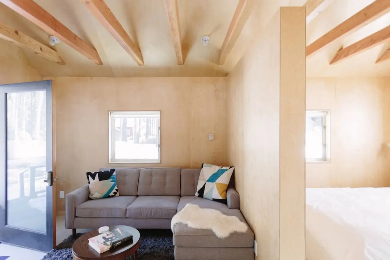 Small + Mighty / C5 living area with couch and soft blankets at Colorado Lodge boutique lodge in Big Bear Lake