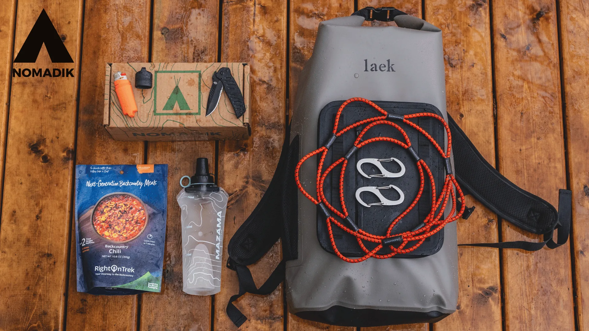 The Nomadik Big Bear Adventure Box with waterproof bag, bottle, knife, and gear for the Colorado Lodge giveaway