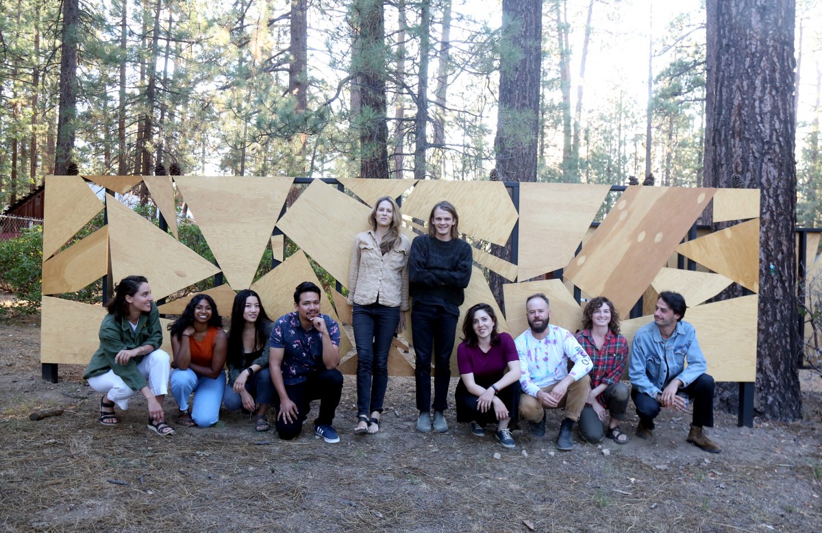 Terremoto Landscape design team gathered in front of the plywood fence they built at Colorado Lodge, Big Bear Lake